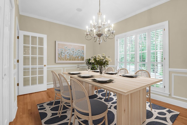 1025 Mathis Ferry Rd, Mount Pleasant, SC 29464 - dining room featuring a chandelier, wood finished floors, healthy amount of natural light, a decorative wall, and ornamental molding