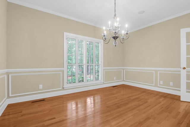 1025 Mathis Ferry Rd, Mount Pleasant, SC 29464 - spare room featuring a chandelier, wood finished floors, ornamental molding, a decorative wall, and a wainscoted wall