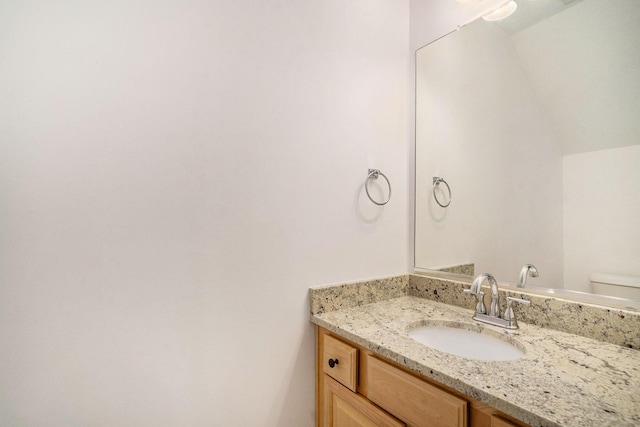 bathroom with toilet and vanity