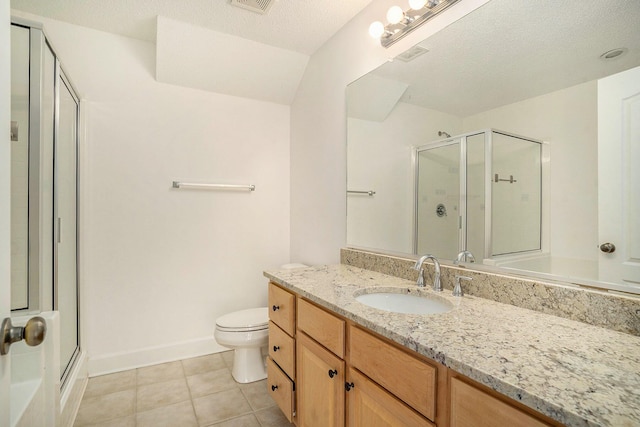 bathroom featuring a textured ceiling, tile patterned flooring, vanity, toilet, and walk in shower