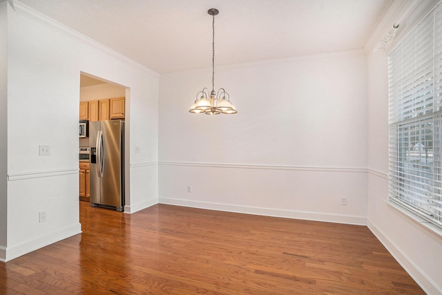 unfurnished room with a notable chandelier, crown molding, and dark wood-type flooring