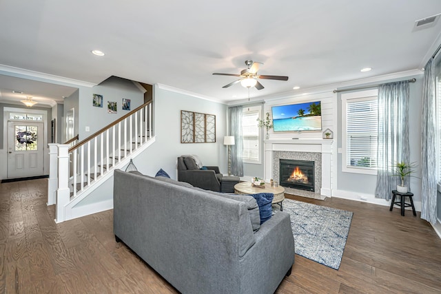 414 Hamlet Cir, Goose Creek, SC 29445 - living room with crown molding, ceiling fan, a fireplace with flush hearth, plenty of natural light, and stairs