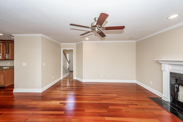 unfurnished living room with a ceiling fan, wood finished floors, stairway, recessed lighting, and a premium fireplace