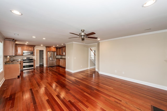 unfurnished living room featuring ceiling fan, baseboards, dark wood-style floors, ornamental molding, and recessed lighting