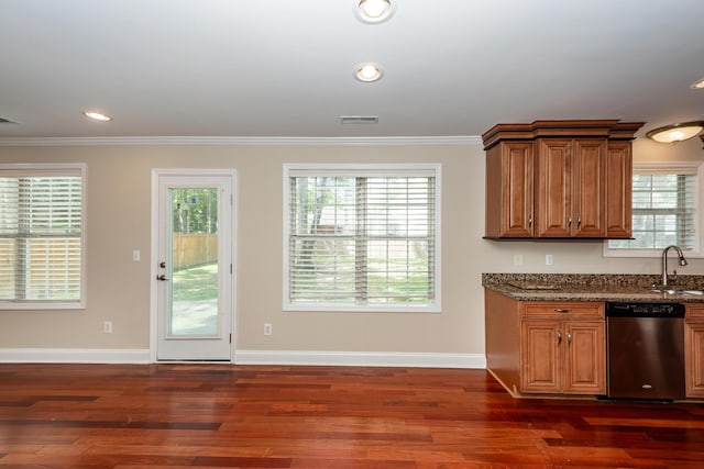 kitchen featuring visible vents, brown cabinetry, ornamental molding, and dishwasher