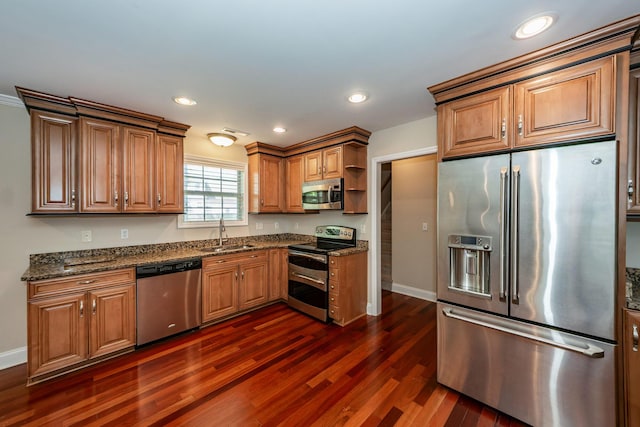 kitchen with open shelves, baseboards, dark wood-type flooring, a sink, and stainless steel appliances