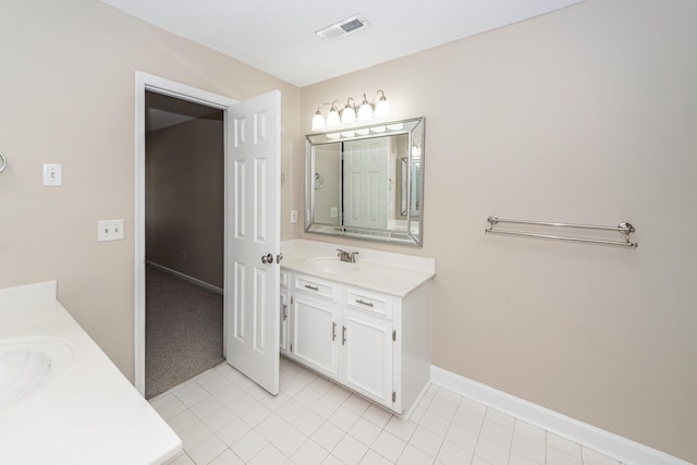 bathroom featuring vanity, baseboards, tile patterned floors, and visible vents