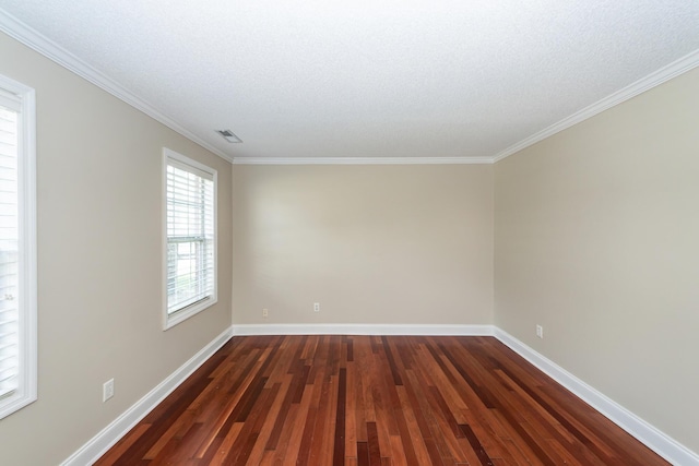 empty room featuring crown molding, baseboards, and dark wood finished floors