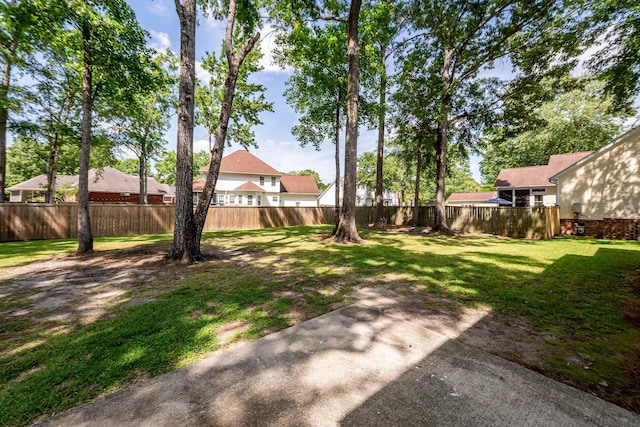 view of yard featuring a fenced backyard and a residential view