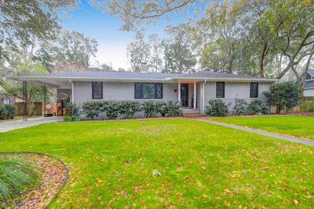 ranch-style home featuring a carport and a front yard