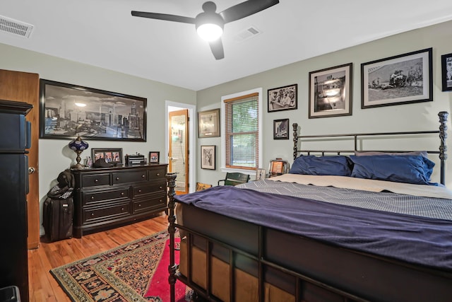 bedroom with ceiling fan, light hardwood / wood-style floors, and ensuite bath