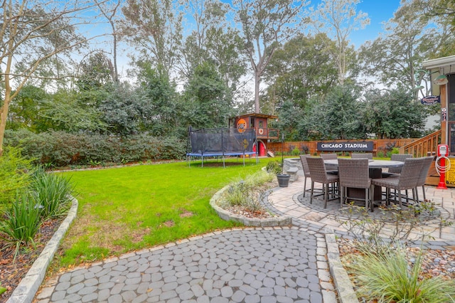 view of yard featuring a playground, a patio area, and a trampoline