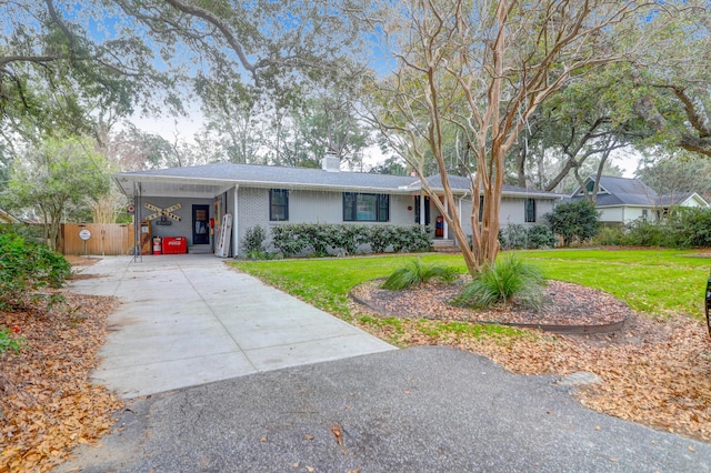 single story home with a front yard and a carport