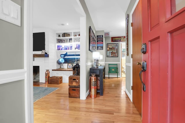 entrance foyer featuring a fireplace and hardwood / wood-style flooring