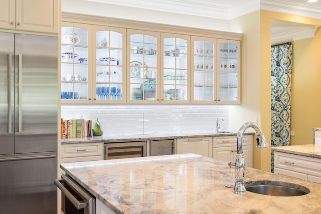 kitchen featuring decorative backsplash, stainless steel built in fridge, wine cooler, and cream cabinets