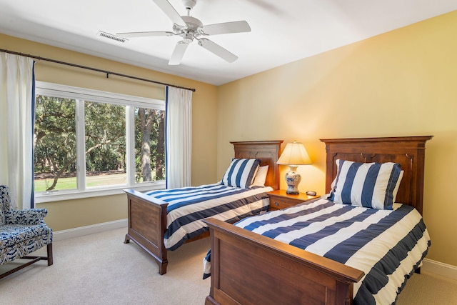 bedroom with ceiling fan and light colored carpet