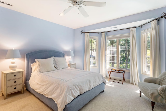 bedroom with light carpet and ceiling fan