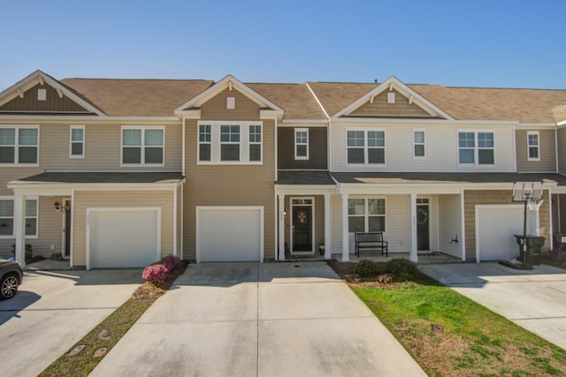 multi unit property featuring a garage and driveway