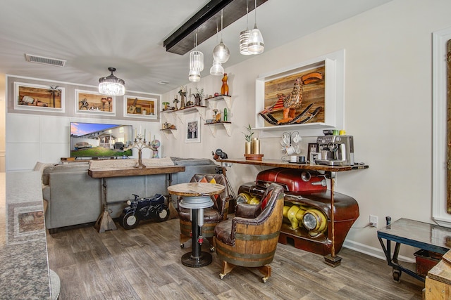 bar with visible vents and wood finished floors