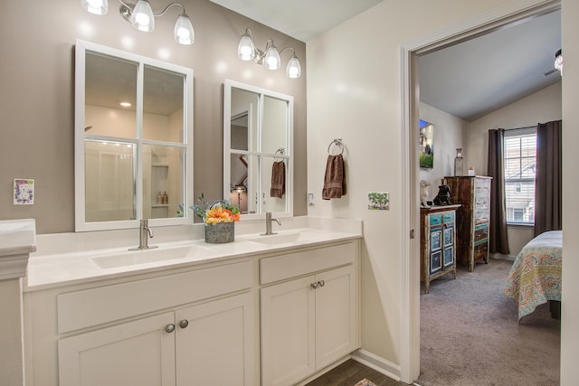 full bathroom with vaulted ceiling, a shower stall, ensuite bathroom, and a sink