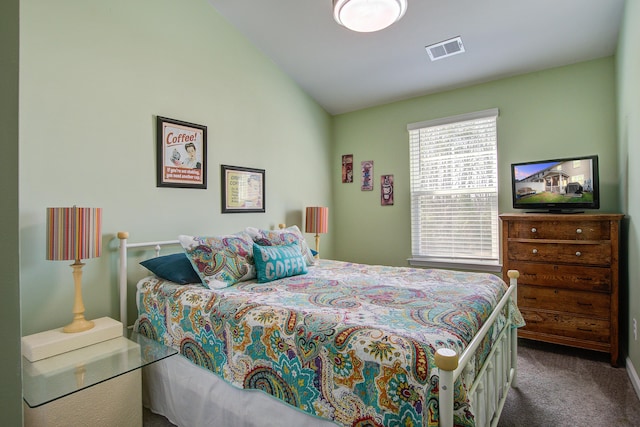 carpeted bedroom featuring visible vents and vaulted ceiling