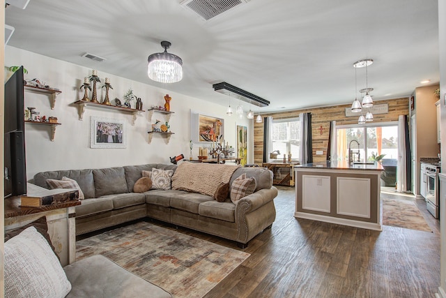 living area featuring visible vents and dark wood-style flooring