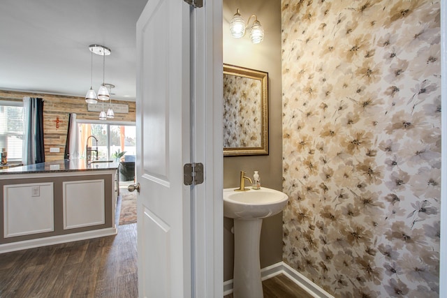 bathroom with baseboards and wood finished floors