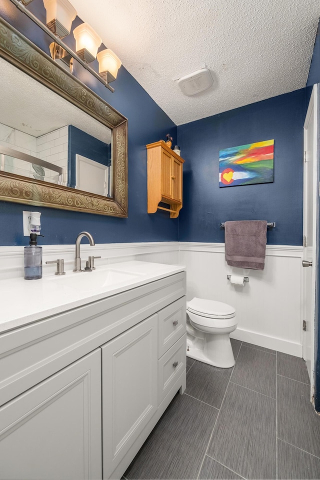 507 Stinson Dr Unit B3, Charleston, SC 29407 - bathroom featuring vanity, a wainscoted wall, a textured ceiling, toilet, and tile patterned floors
