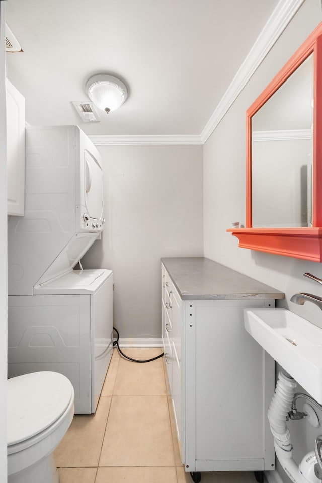 507 Stinson Dr Unit B3, Charleston, SC 29407 - bathroom with stacked washer and clothes dryer, toilet, ornamental molding, and tile patterned flooring