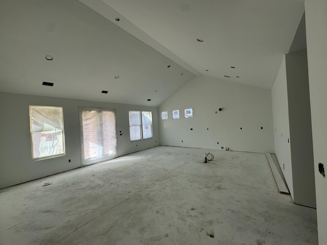 spare room featuring high vaulted ceiling and beam ceiling