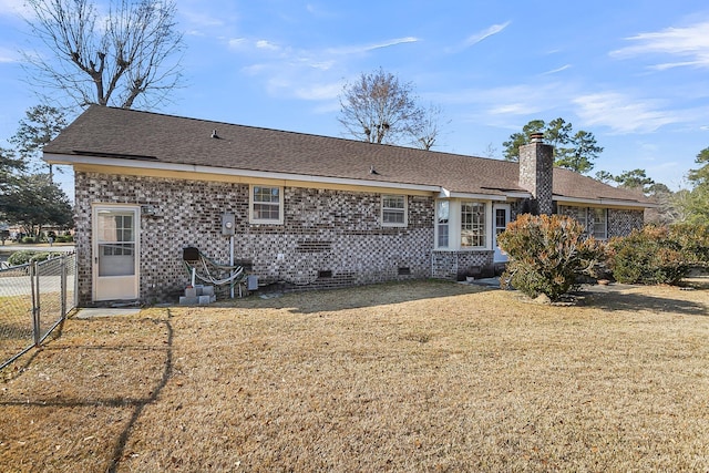 back of property featuring a lawn