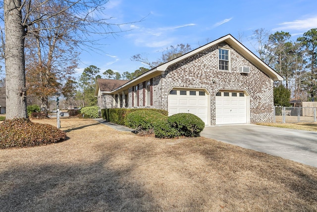 view of side of property featuring a garage and an AC wall unit