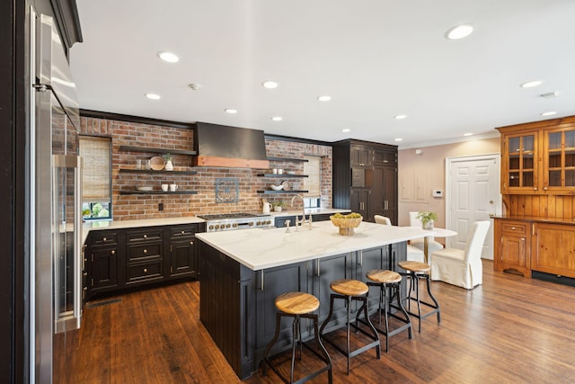 2 Bedons Aly, Charleston, SC 29401 - kitchen featuring stainless steel appliances, wall chimney range hood, open shelves, a breakfast bar area, and dark wood finished floors