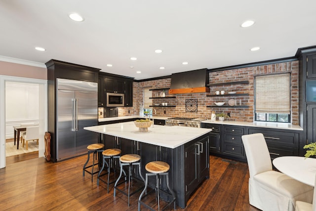 2 Bedons Aly, Charleston, SC 29401 - kitchen featuring stainless steel appliances, premium range hood, open shelves, ornamental molding, and a kitchen breakfast bar