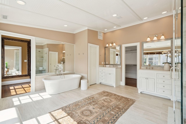 2 Bedons Aly, Charleston, SC 29401 - full bath featuring vanity, crown molding, a stall shower, a soaking tub, and a walk in closet