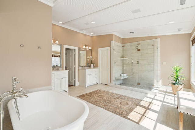 2 Bedons Aly, Charleston, SC 29401 - bathroom featuring a freestanding bath, crown molding, vanity, a stall shower, and recessed lighting