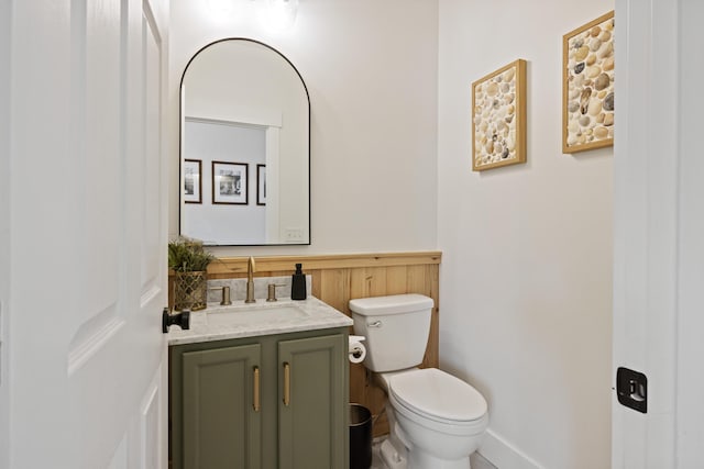 half bathroom with toilet and vanity