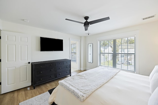 bedroom with a ceiling fan, visible vents, and light wood-type flooring