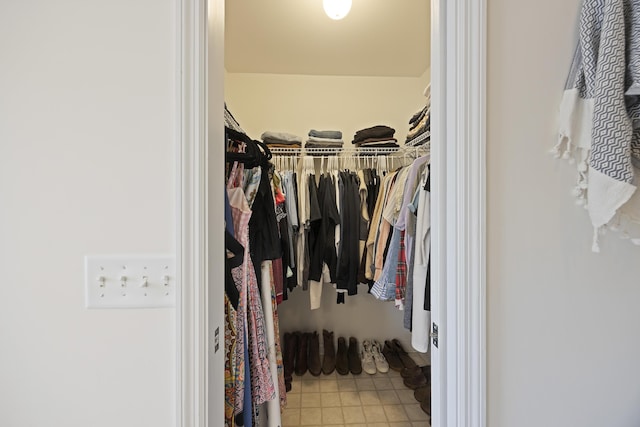 walk in closet featuring tile patterned flooring