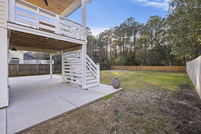 view of yard with stairs, a patio area, and a fenced backyard