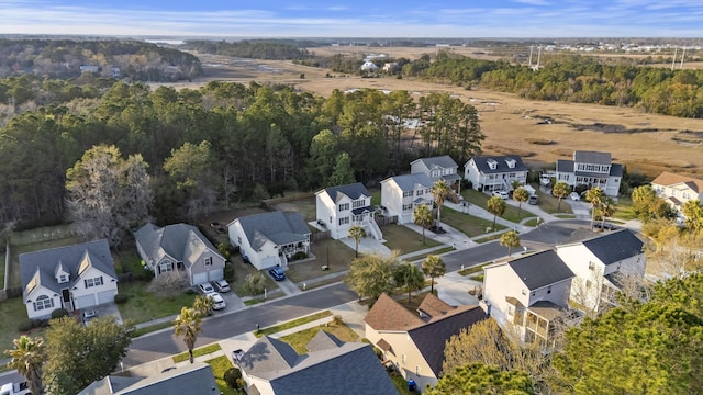 bird's eye view with a wooded view and a residential view