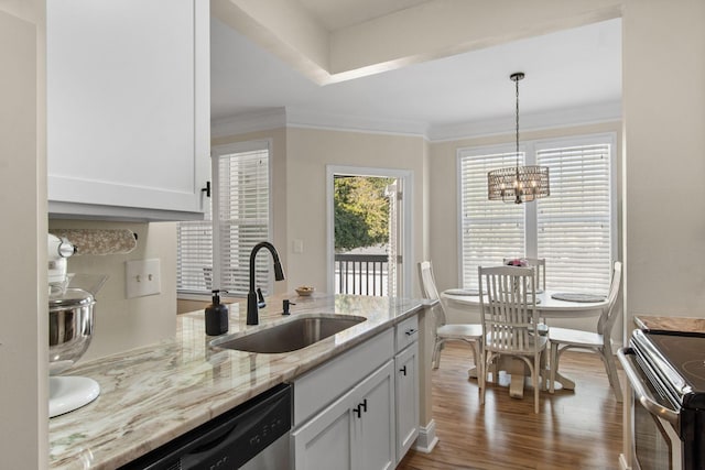 kitchen featuring light stone counters, a sink, dark wood finished floors, and crown molding