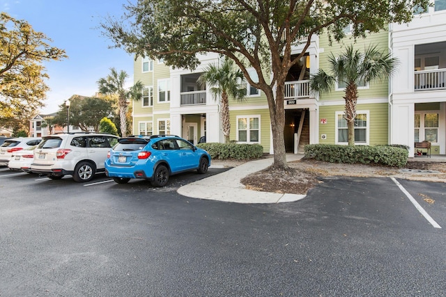 view of building exterior featuring uncovered parking