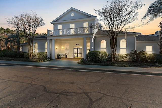 greek revival inspired property featuring a balcony