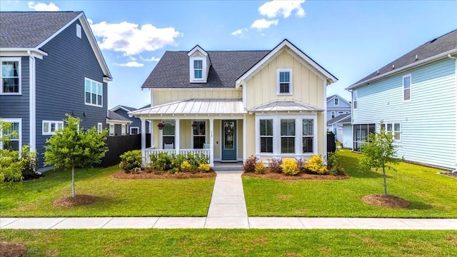 113 Grimball St, Summerville, SC 29486 - view of front facade featuring board and batten siding, a porch, a standing seam roof, a front yard, and a shingled roof
