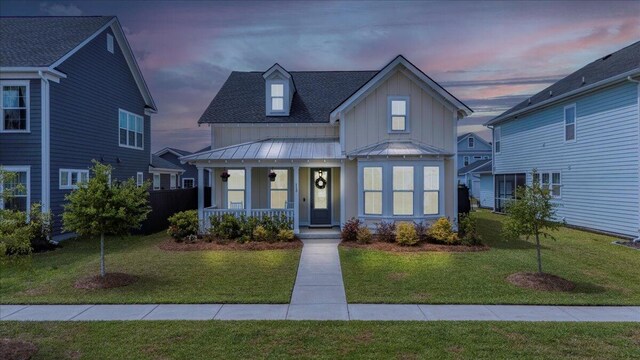 113 Grimball St, Summerville, SC 29486 - view of front of house with covered porch, board and batten siding, a lawn, and a standing seam roof
