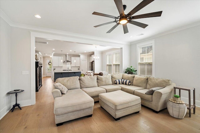 113 Grimball St, Summerville, SC 29486 - living room featuring ceiling fan, ornamental molding, a chandelier, baseboards, and light wood-style flooring