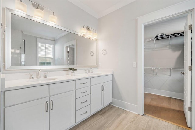 113 Grimball St, Summerville, SC 29486 - bathroom with wood finished floors, a spacious closet, baseboards, double vanity, and crown molding