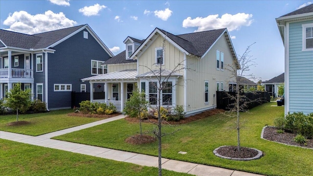 113 Grimball St, Summerville, SC 29486 - view of front of home with board and batten siding, covered porch, a front lawn, and roof with shingles