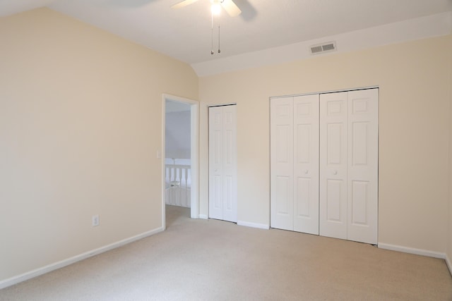 403 Sunny Side Way, Summerville, SC 29485 - unfurnished bedroom featuring two closets, light carpet, lofted ceiling, baseboards, and a ceiling fan